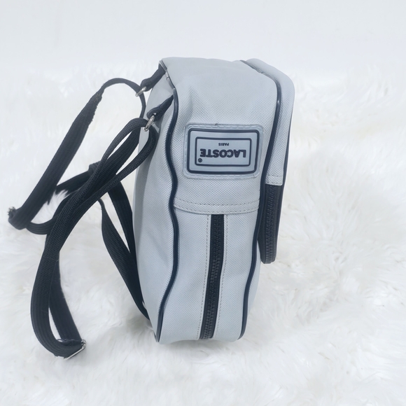 Lacoste mini backpack in a soft light blue shade with navy blue trim accents. - Picture 9 of 16